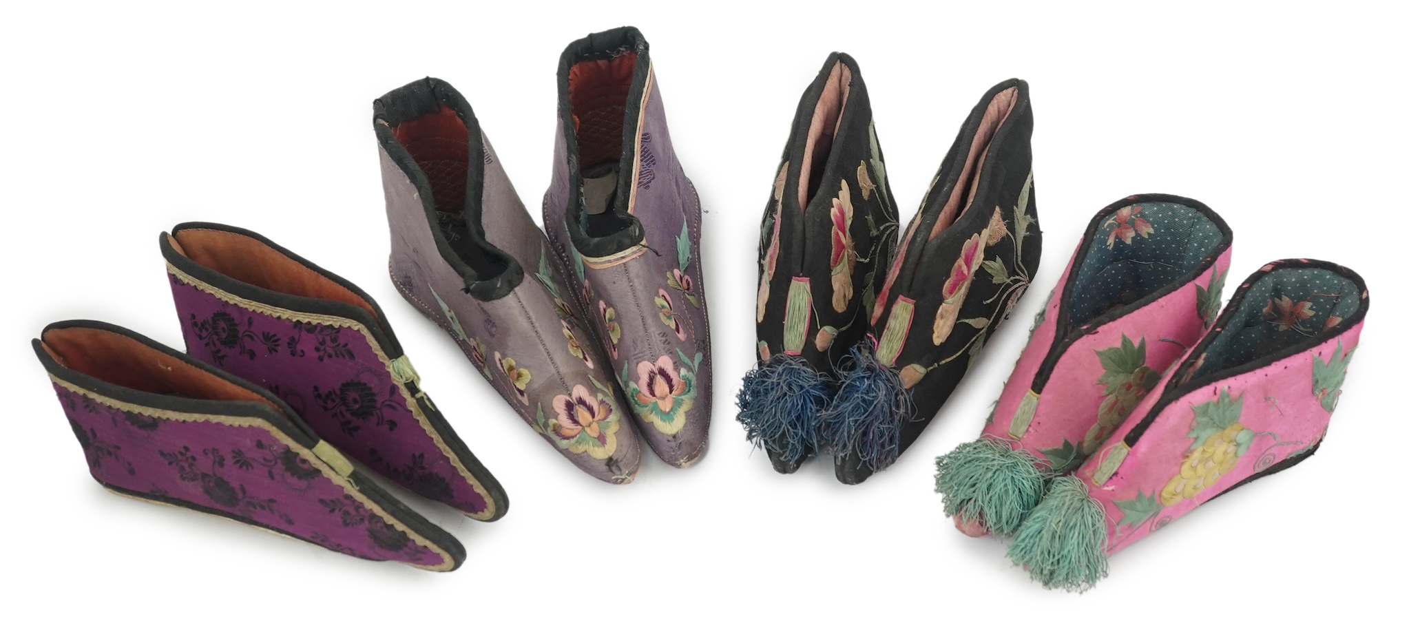 Four pairs of late 19th / early 20th Chinese ladies bound foot shoes, made in various coloured silks, with colourful floral embroidered motifs, two pairs with decorative silk pom-poms and another made of purple and black